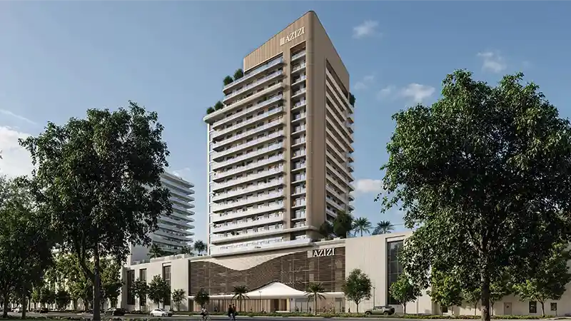 Exterior view of the Azizi David residential tower surrounded by greenery in Dubai.
